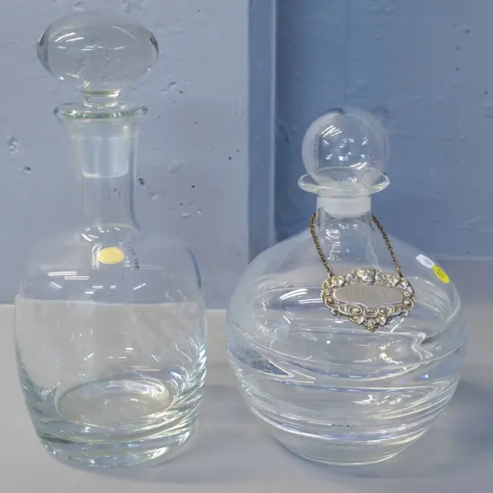 2 heavy clear glass stoppered decanters, one with metal whisky label, taller H-280 marked Romania