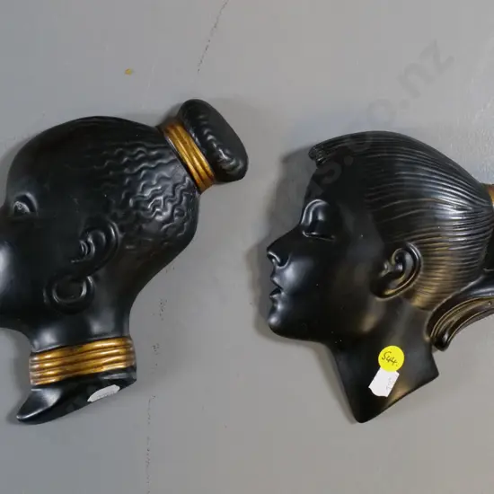 two black plaster wall silhouette heads - small chip on back of one, larger is H-180