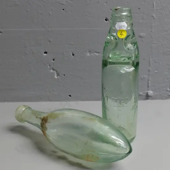 Lanes clear marble bottle and an unmarked torpedo bottle