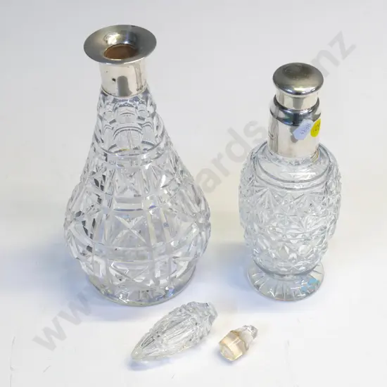 2 sterling silver mounted cut crystal decanters - one has broken stopper, sterling stopper on shorter one is stuck fast