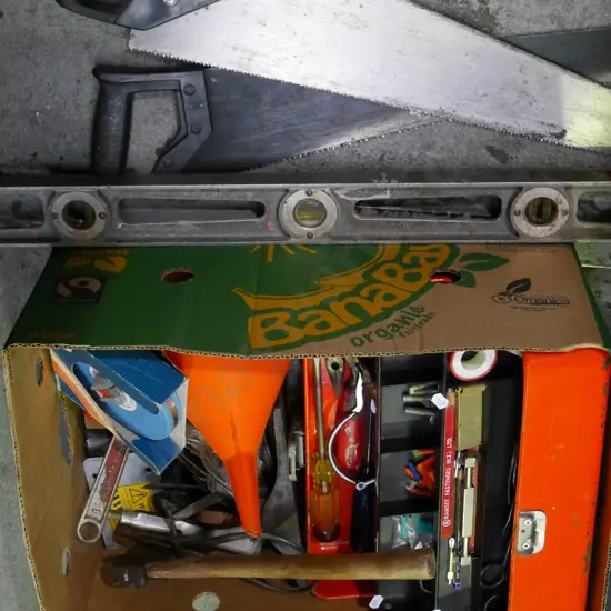 box; hand saws, builder's level, hatchet, hand plane, builder's tape, adjustable crescent etc