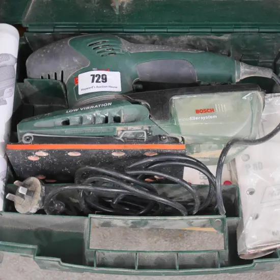 Bosch cased orbital sander with additional sanding pads