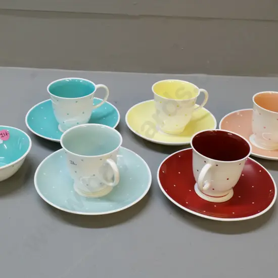 5 various coloured Susie Cooper coffee cups & saucers and a sugar bowl