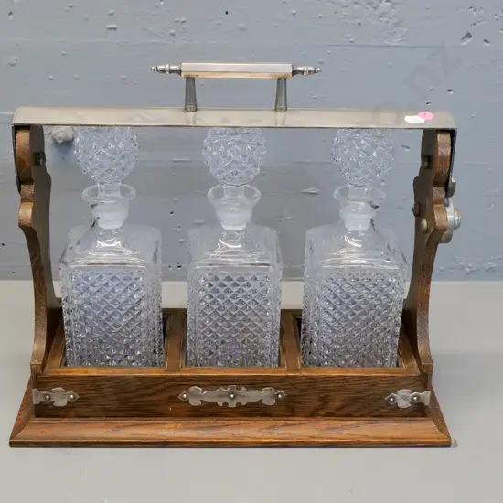 oak tantalus with 3 glass decanters, metal handle and corner binding H370 W410 D160