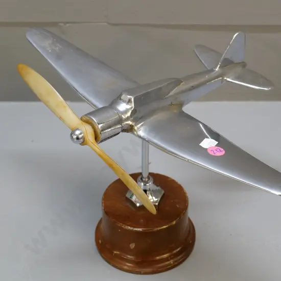 chrome aeroplane model with oversized bakelite or plastic propeller, on stand and wooden base H-200 W-310