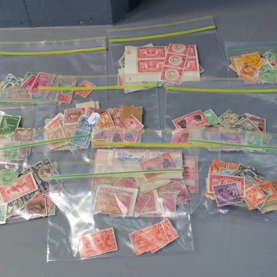 11 small packets of vintage New Zealand stamps, including 1930s Health stamps, most used but some not