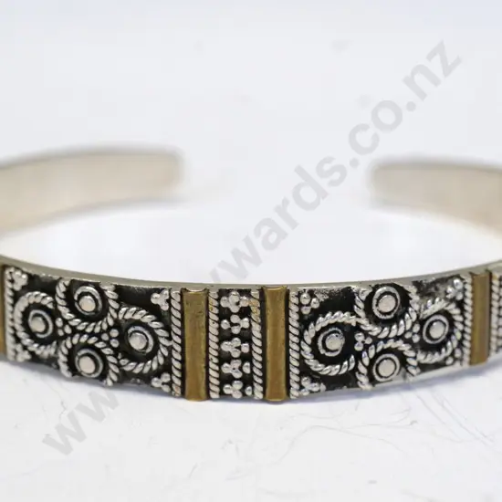silver cuff bangle with design on top half