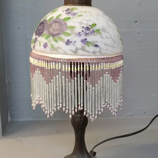 reproduction table lamp with bronzed finish, hand-painted mottled glass shade and beaded fringe H-440