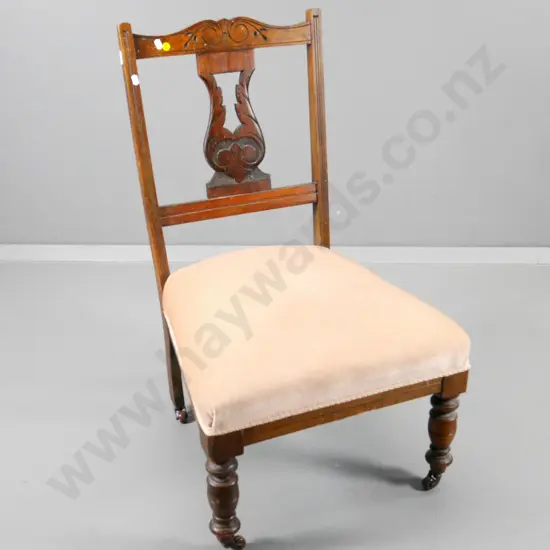 Edwardian mahogany nursing chair with carved back, original porcelain casters, pink velvet upholstery H790 W480 D460