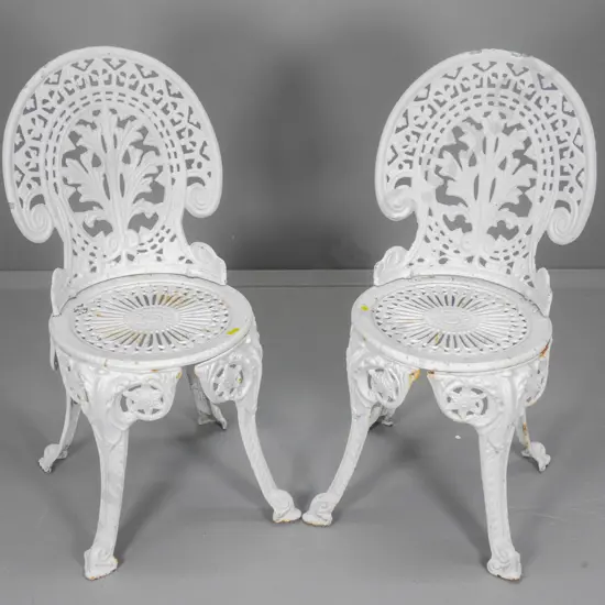 pair of Victorian style white painted cast iron garden chairs - some chips & surface corrosion H860 W390 D430