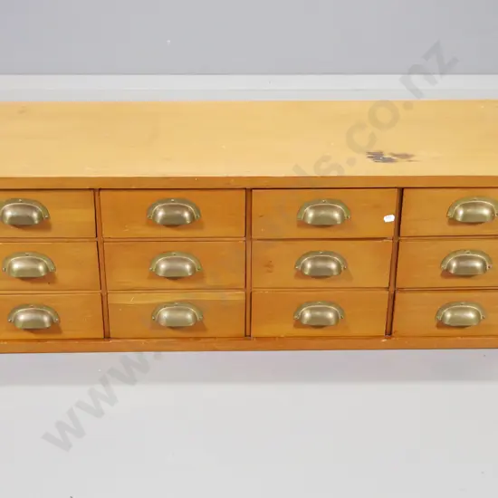vintage kauri cabinet of 12 office drawers with brass cup handles - cracks, chip to top H330 W1050 D410