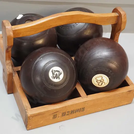 4 lawn bowls with bone insets, in wooden carrier - one is missing one inset