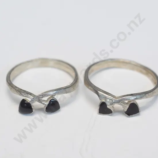 2 silver rings with 2 small red hearts stamped 925
