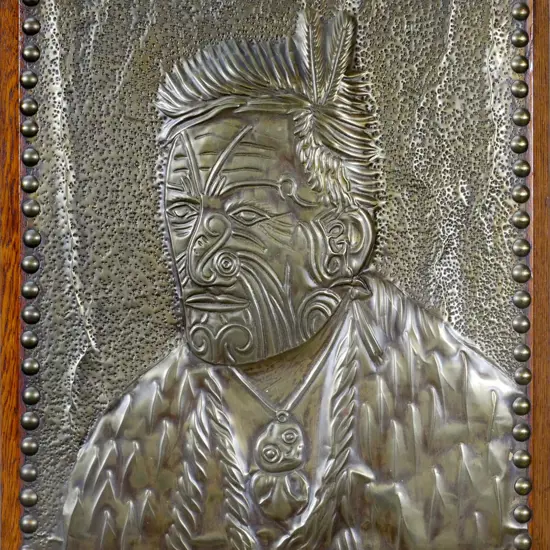 beaten brass Maori male portrait on solid oak background  H-330 W-270