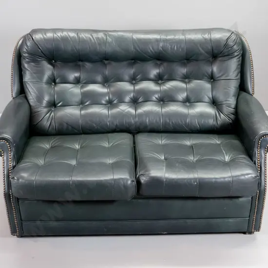 green leather 2-seater settee with button back and seat, brass studding, some rubbing to leather finish H850 W1300 D800