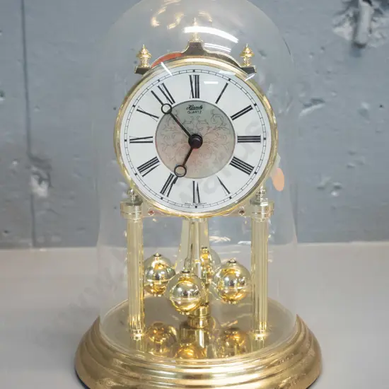 Hermle German plastic and metal quartz movement anniversary clock with glass dome H-230 D-160 at base